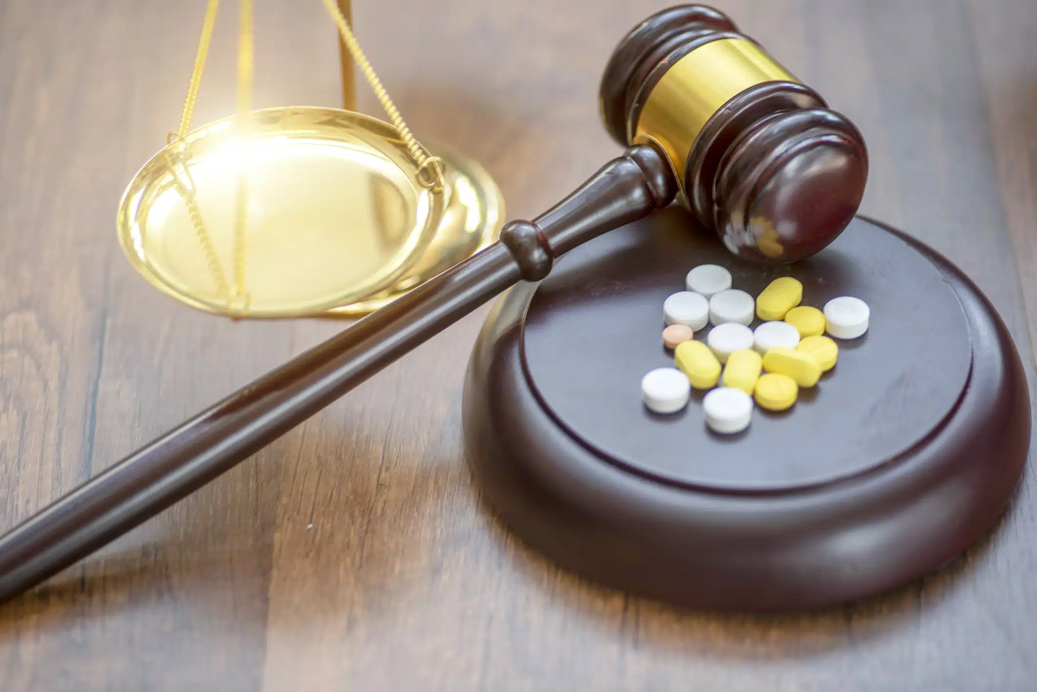A set of pills sits on a gavel in a drug injury law office in Oklahoma.