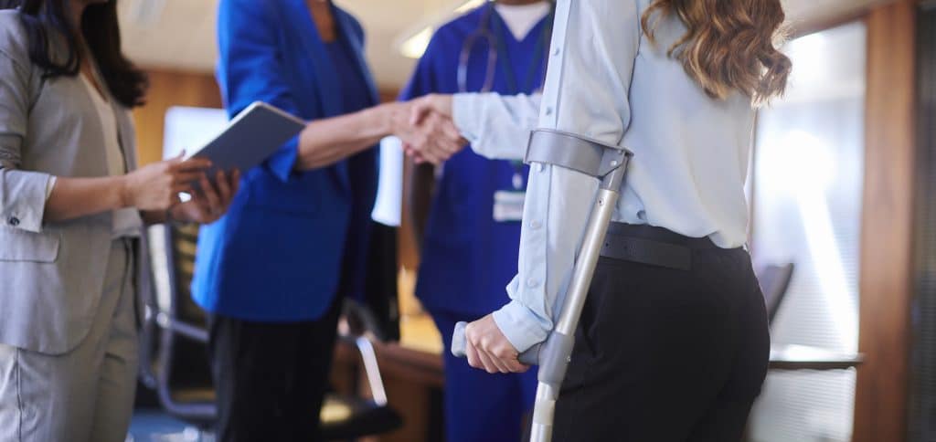 A lawyer shaking the hand of an injured client in Oklahoma.