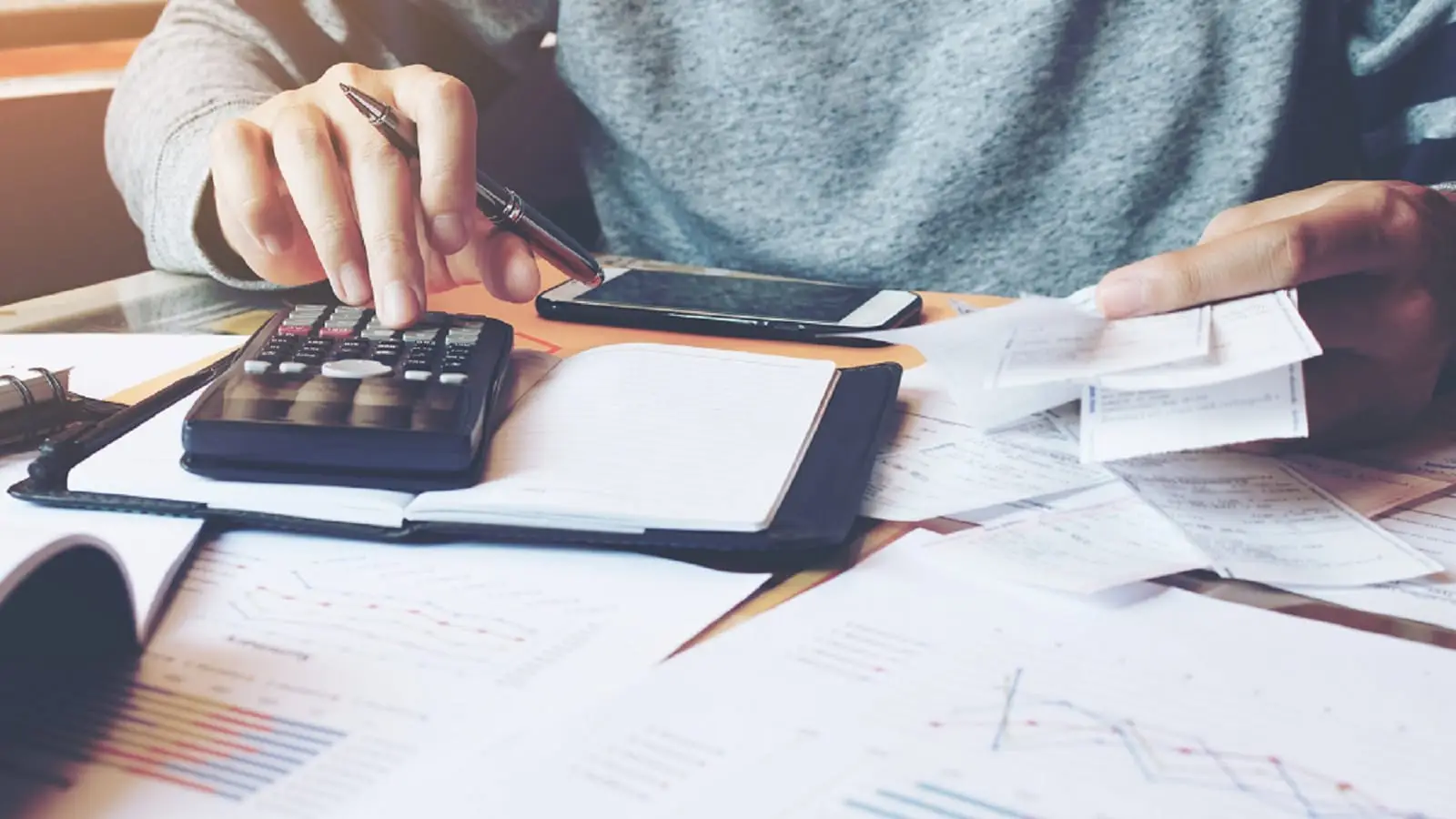 Man Using Calculator Stock Photo