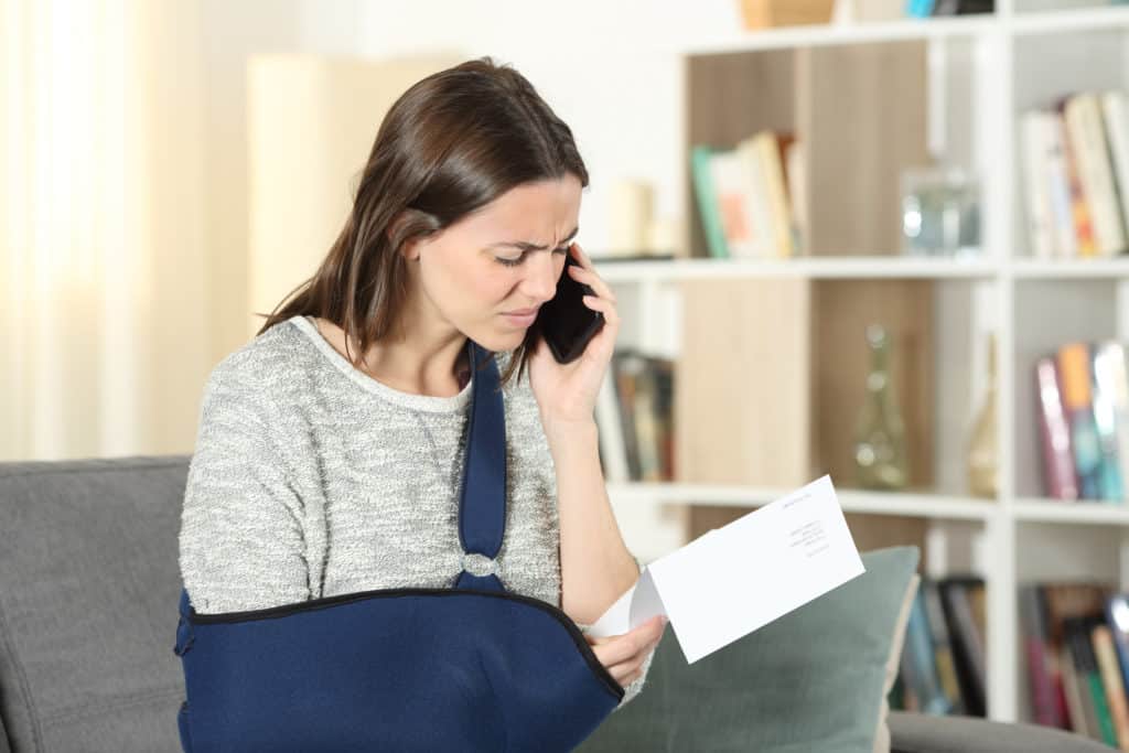 An injured woman on the phone with her Ardmore, OK, personal injury lawyer.