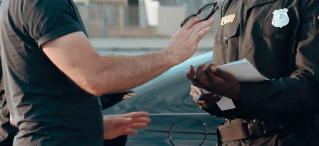 A person talking with a police officer after a car accident