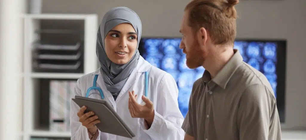 A person meeting with a medical professional after a car accident