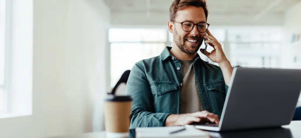 A person smiling while on the phone with a car accident lawyer