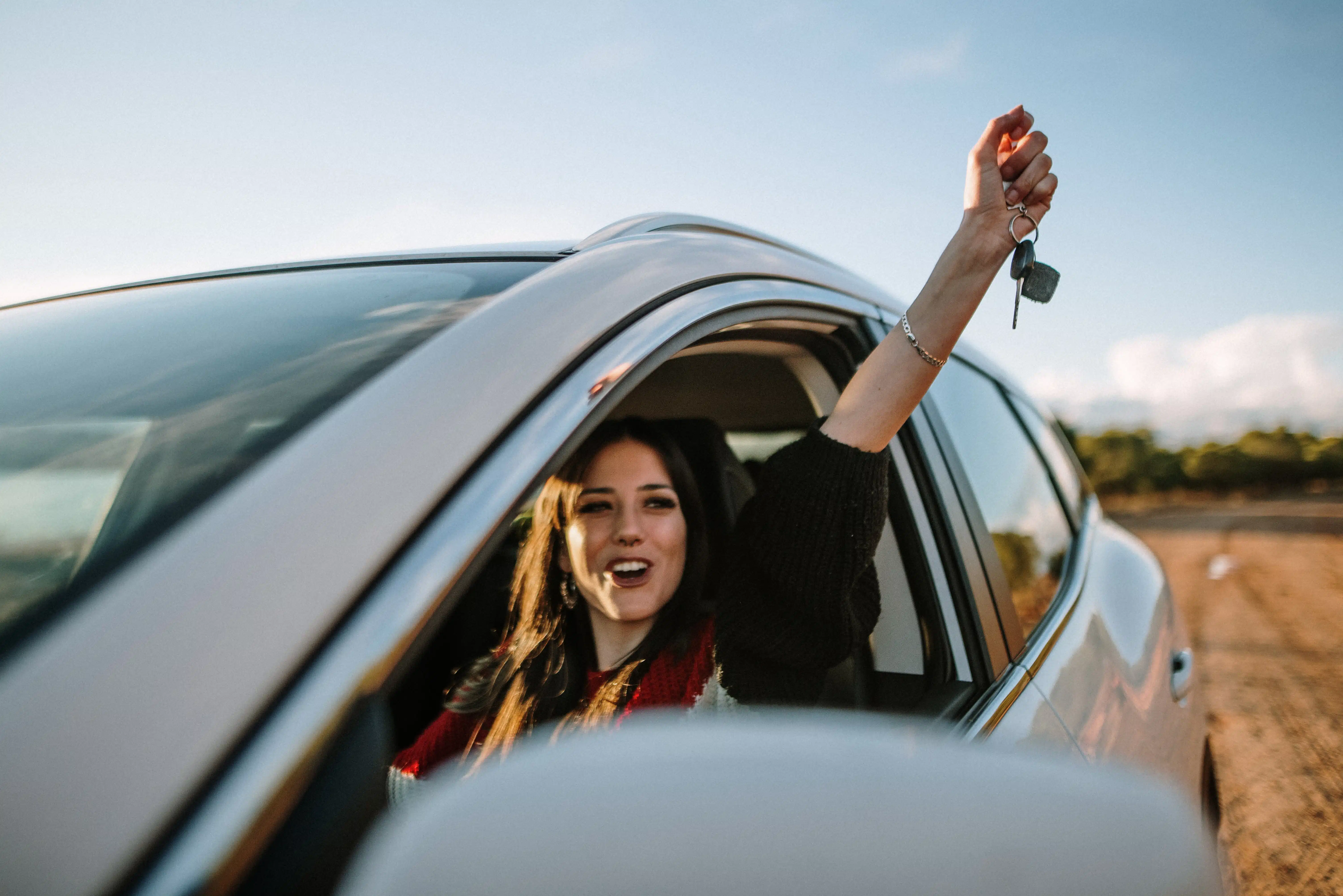 young-woman-proudly-holds-up-car-keys