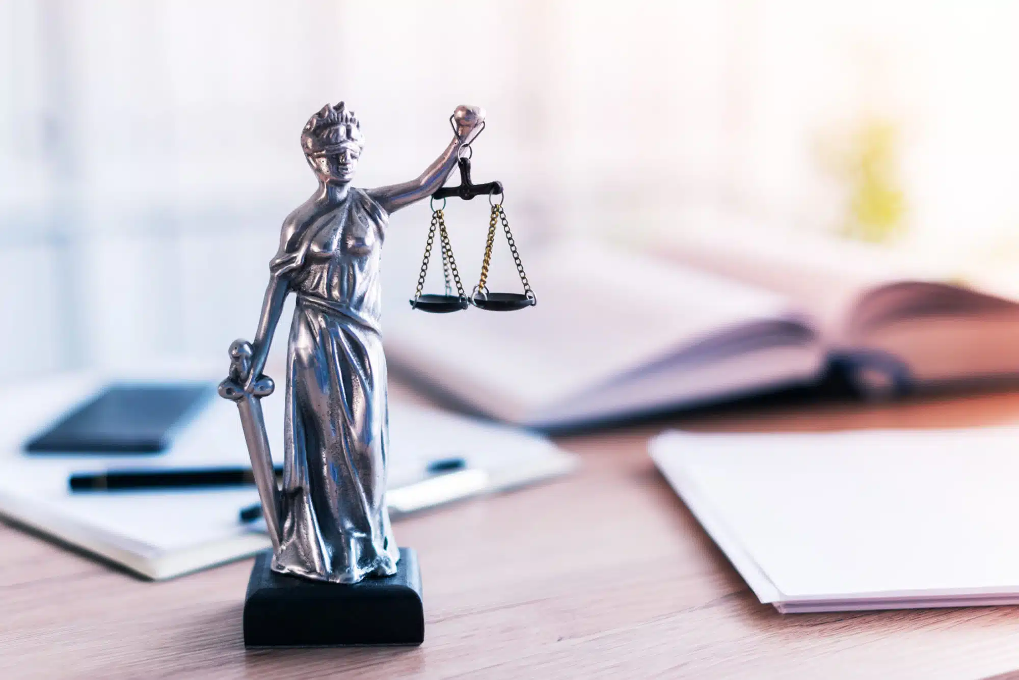 Lady Justice sitting on a personal injury lawyers desk