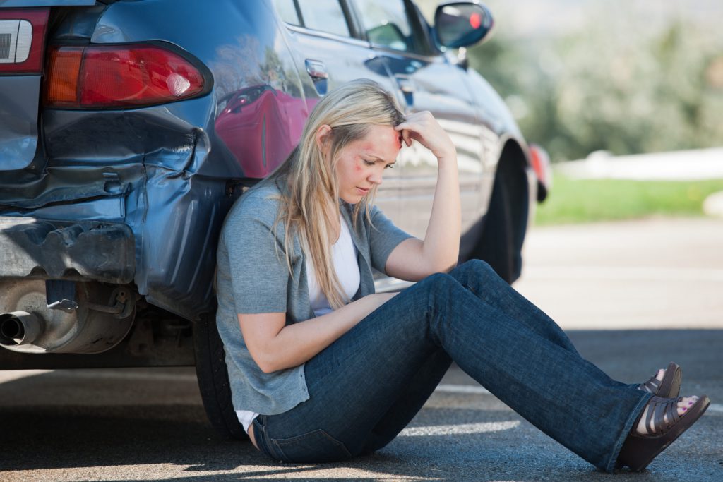 Female Accident Victim Waits Outside of Her Car