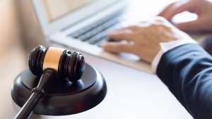 Lawyer Typing On Laptop Computer Stock Photo