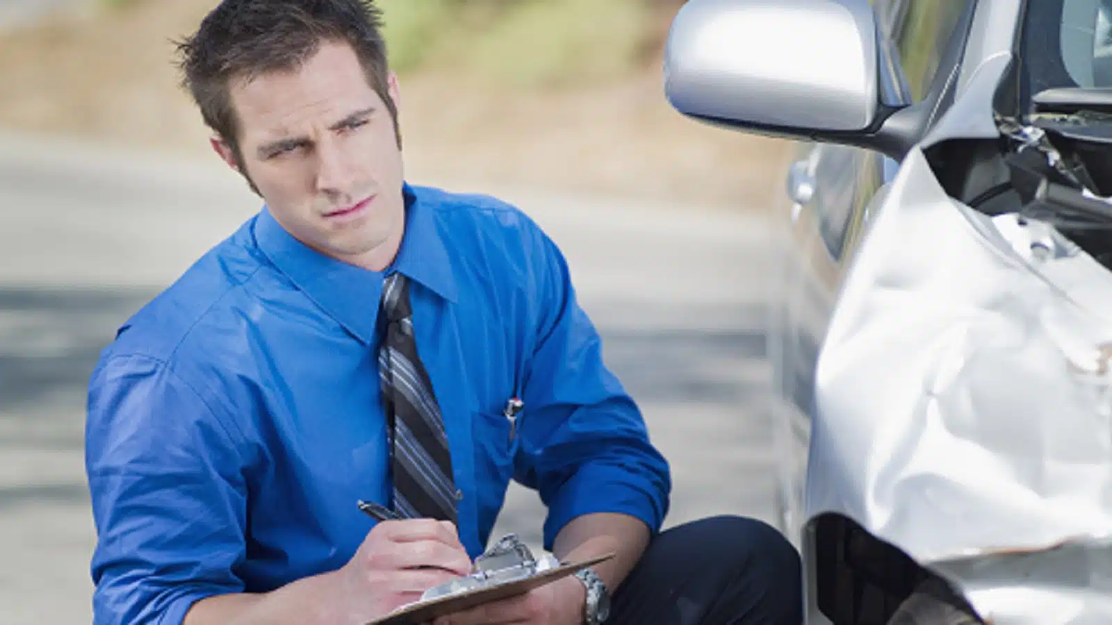 Insurance Adjuster Examining Car Accident Stock Photo