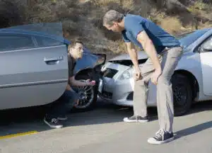 two men examining the damage after an Oklahoma City car accident
