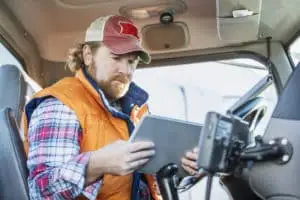a truck driver checking his logs before hitting the roads in Oklahoma City