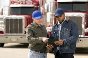 Two Oklahoma City semi-truck drivers discussing their loads