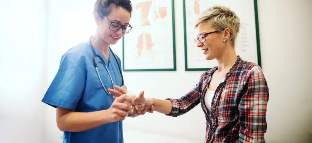 A woman meeting with a medical professional and being examined