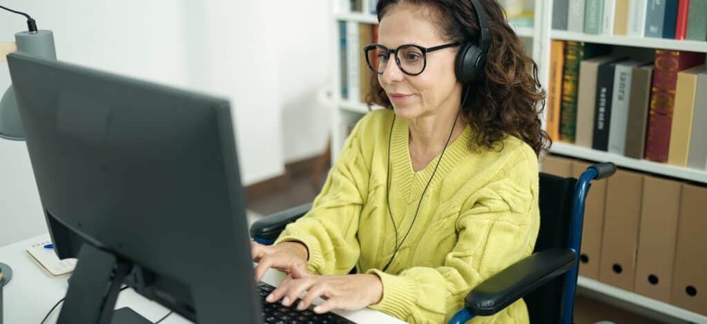 A woman with headphones working at a computer