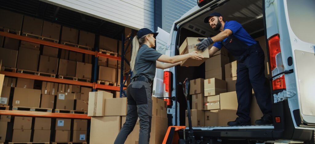 Two people unloading a delivery truck