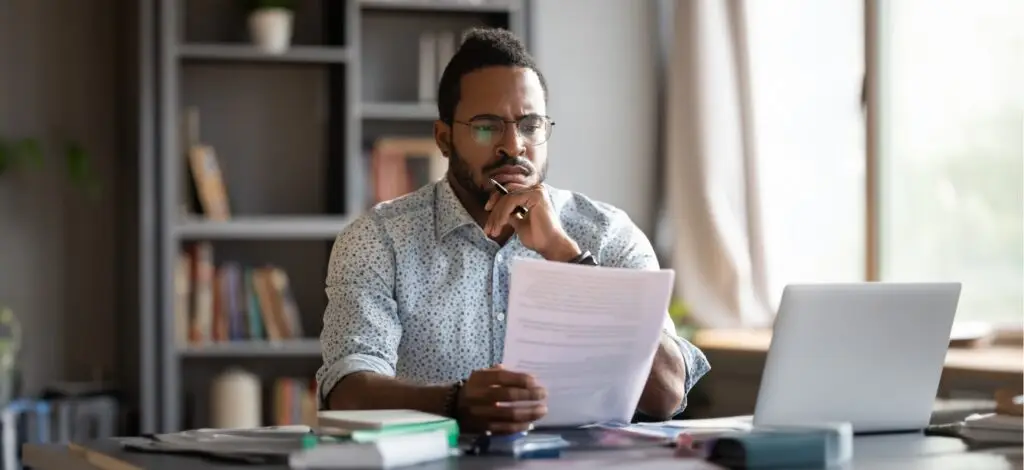 A man focused on reading a document