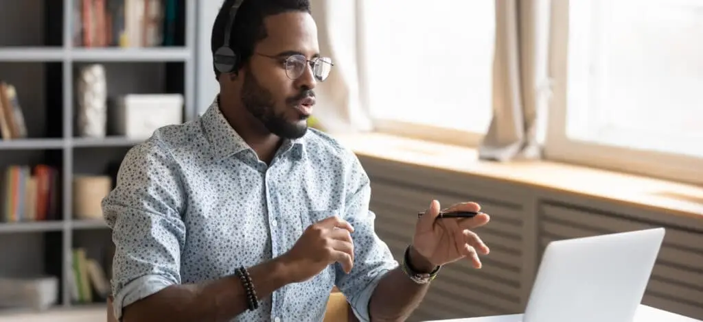 Young man talking to an insurance adjuster via video conference