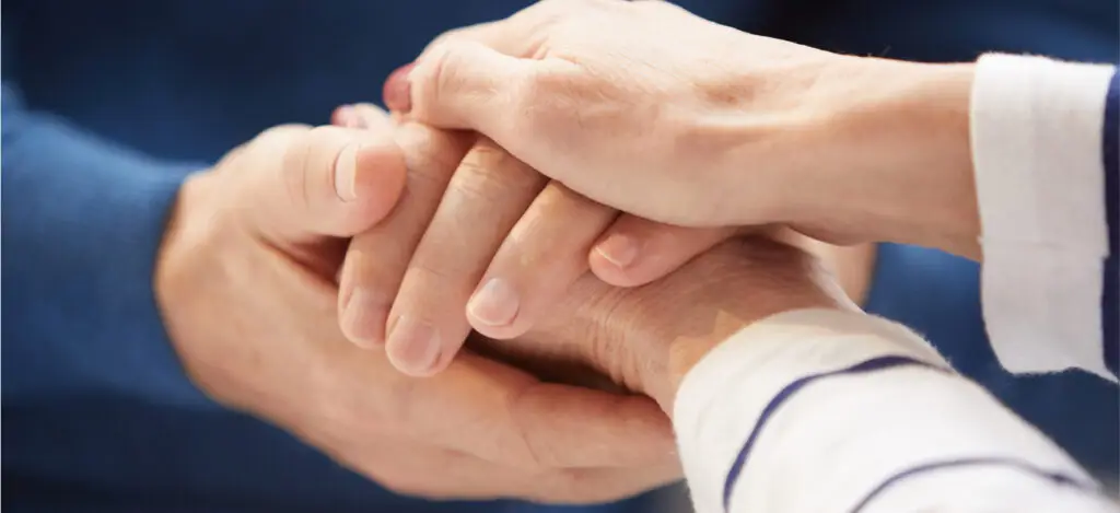 A close-up of two people's hands together