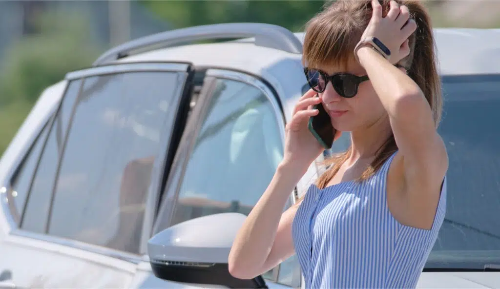 A woman talks on the phone after a car crash
