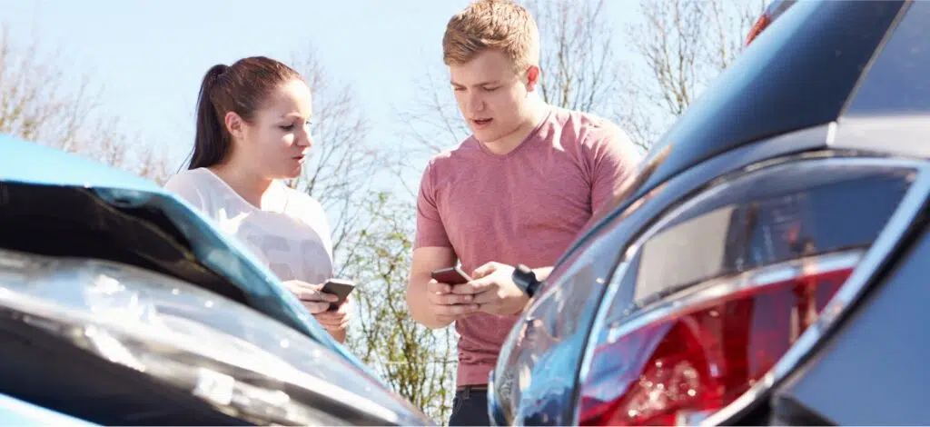 Two people involved in a car crash swap insurance info