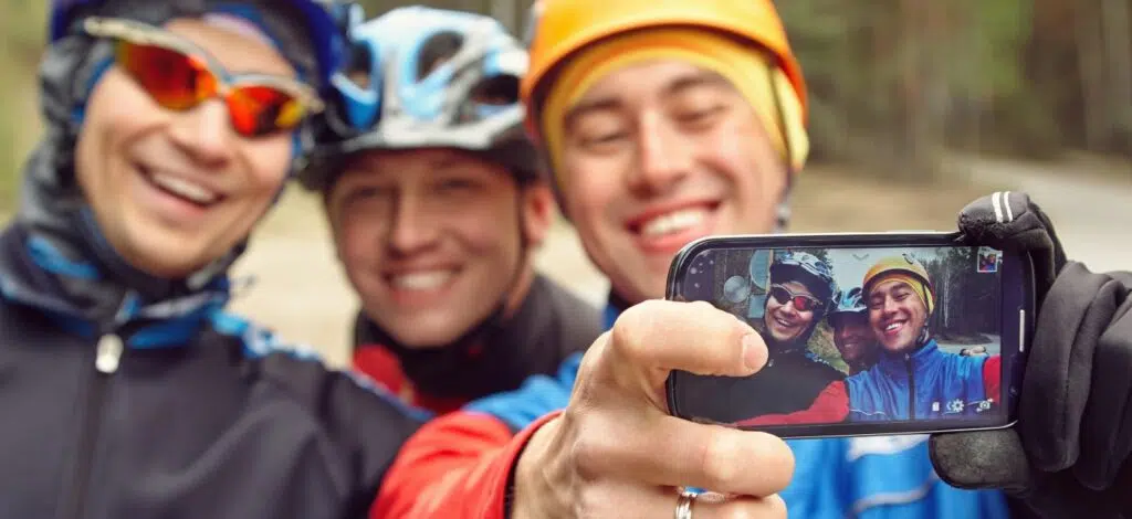 A group of outdoor enthusiasts take a selfie on the trail
