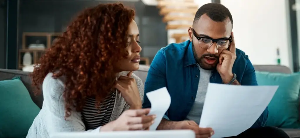 Two people reviewing paperwork after a car accident
