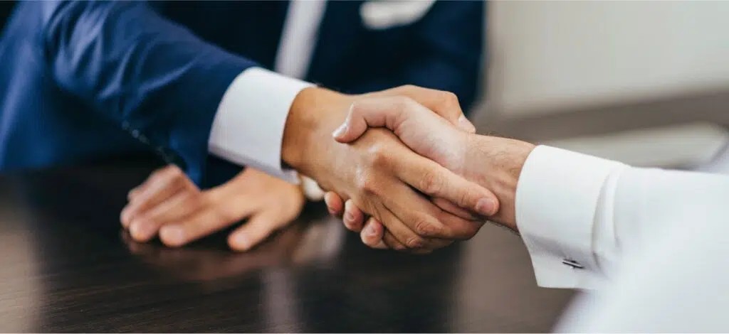 A closeup of two people shaking hands