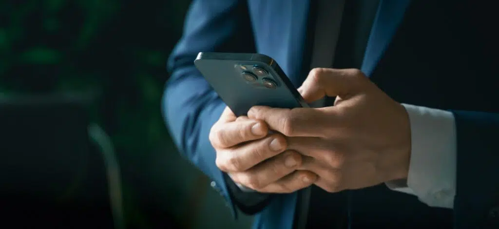 A person uses a mobile phone to contact a truck accident lawyer.