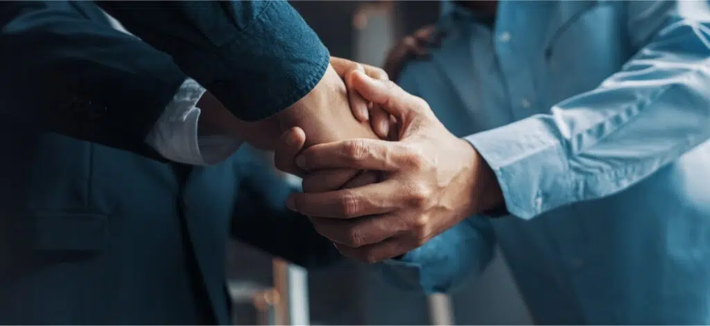 An Oklahoma truck accident lawyer shakes hands with a new client.