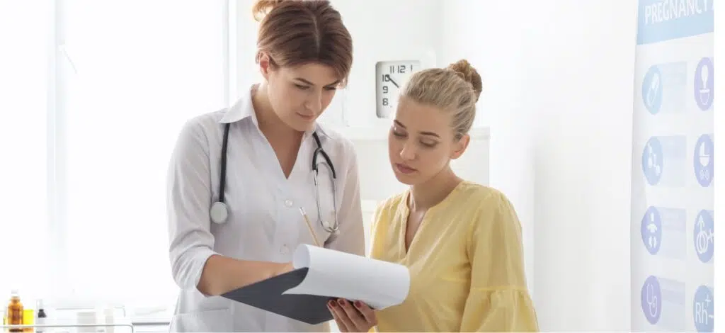 A woman consulting with a doctor after a car crash