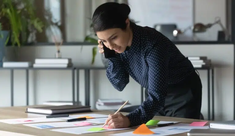 a person on the phone and taking notes about a social security disability claim