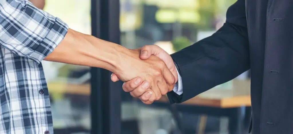 a person shaking hands with a disability lawyer
