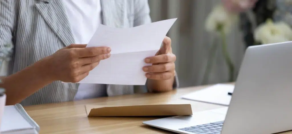 a person reviewing a letter that came in an envelope