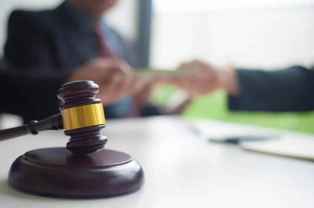 closeup of a gavel with people in the background