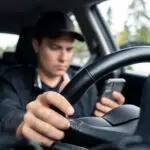 Driving car and using phone to text. Driver using cellphone. Accident, crash and danger in traffic. Man texting with mobile app. Distracted by mobilephone. Checking sms message with smartphone.
